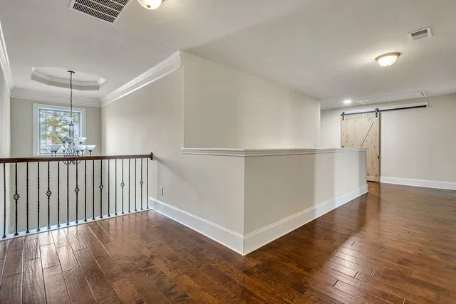 a view of a livingroom with furniture a ceiling fan and wooden floor