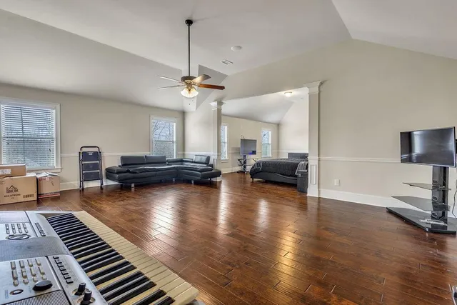 a bedroom with a bed and a television