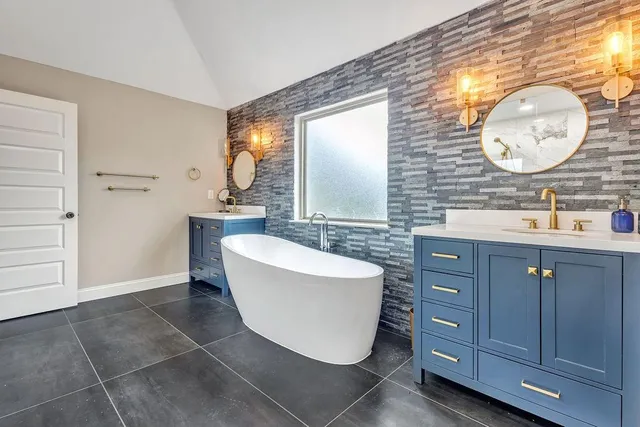 a living room with furniture a rug and white walls