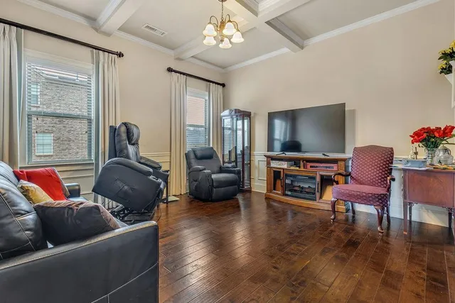 a living room with furniture a ceiling fan and a rug