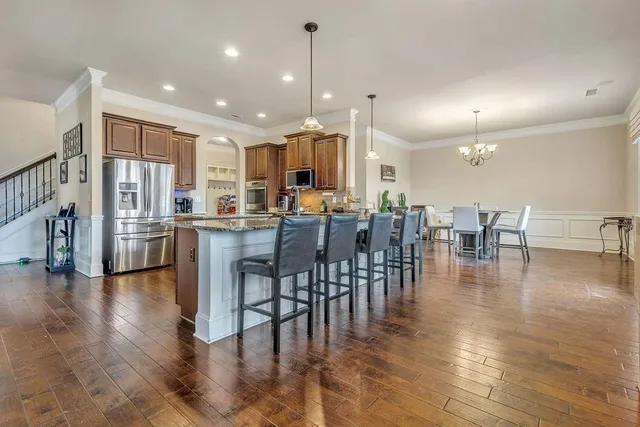 a kitchen with stainless steel appliances sink stove microwave and cabinets