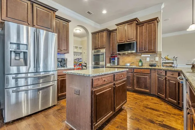 a dining room with furniture a rug and a chandelier