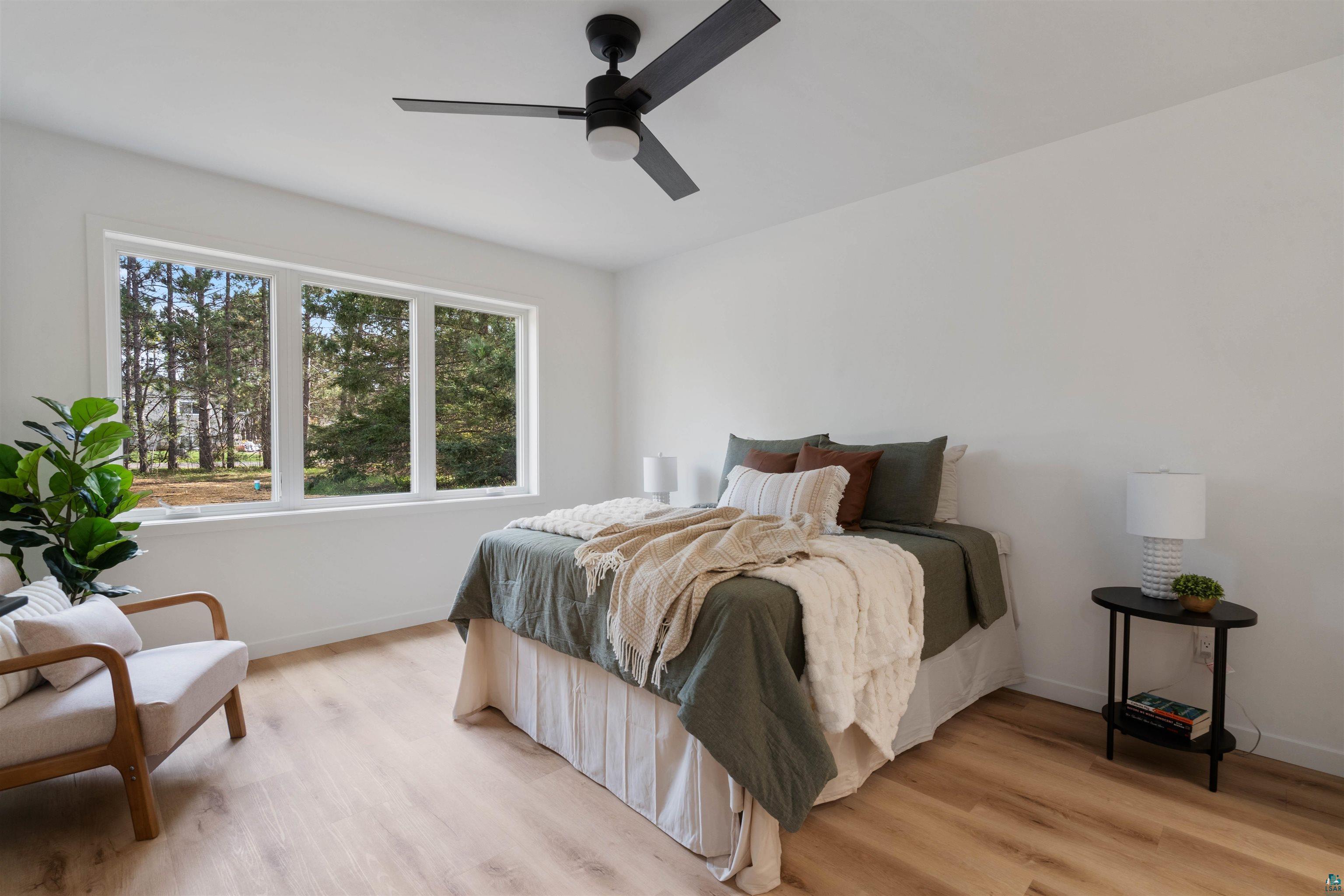 1386 Stephen Road Cloquet, MN 55720 - Photo 15 of 25 Bright interior space featuring a multi-pane window, light wood-finish flooring, a contemporary ceiling fan, and white wall finishes
