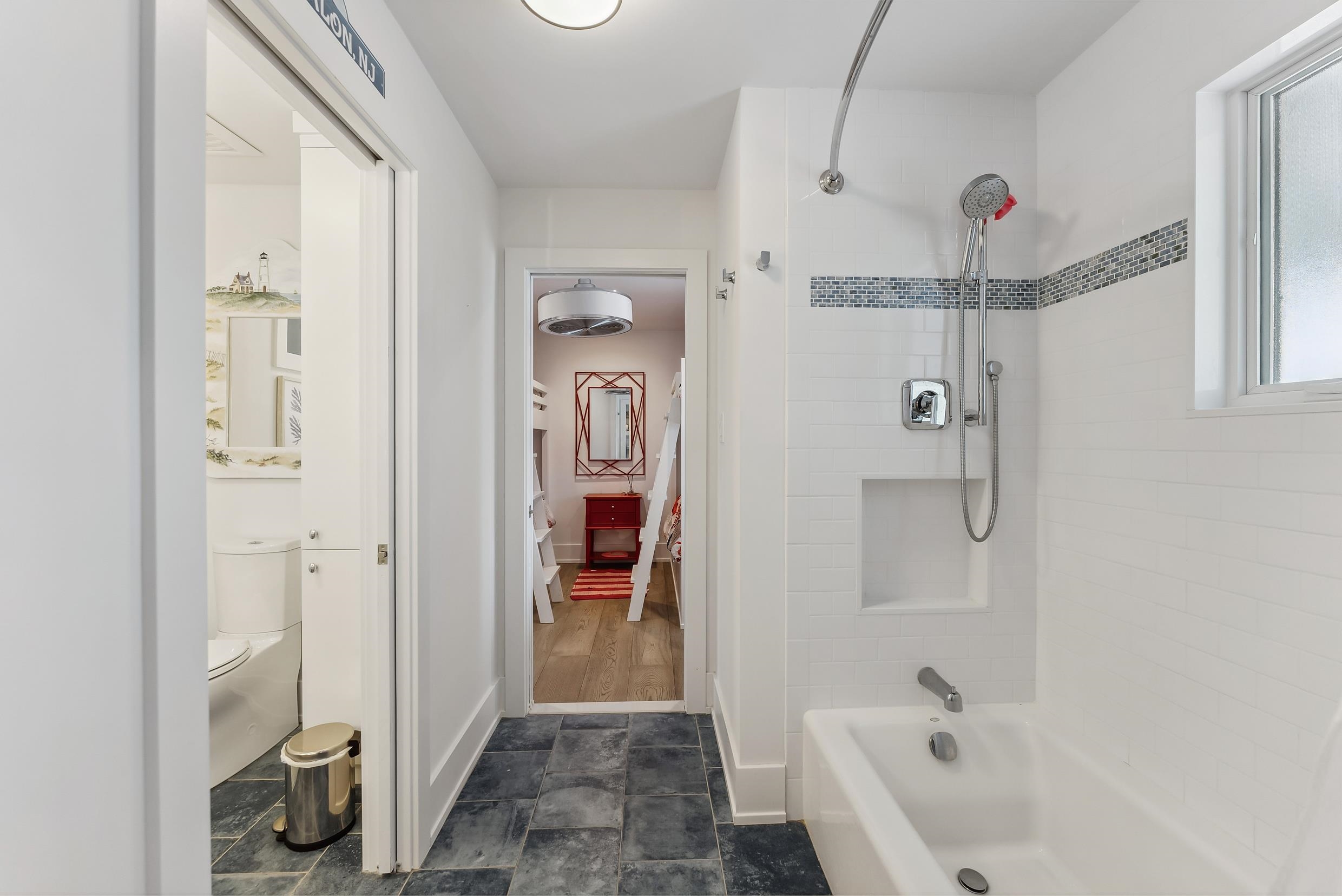 7749 Dune Drive Avalon, NJ 08202 - Photo 16 of 44 a bathroom with a tub shower and sink