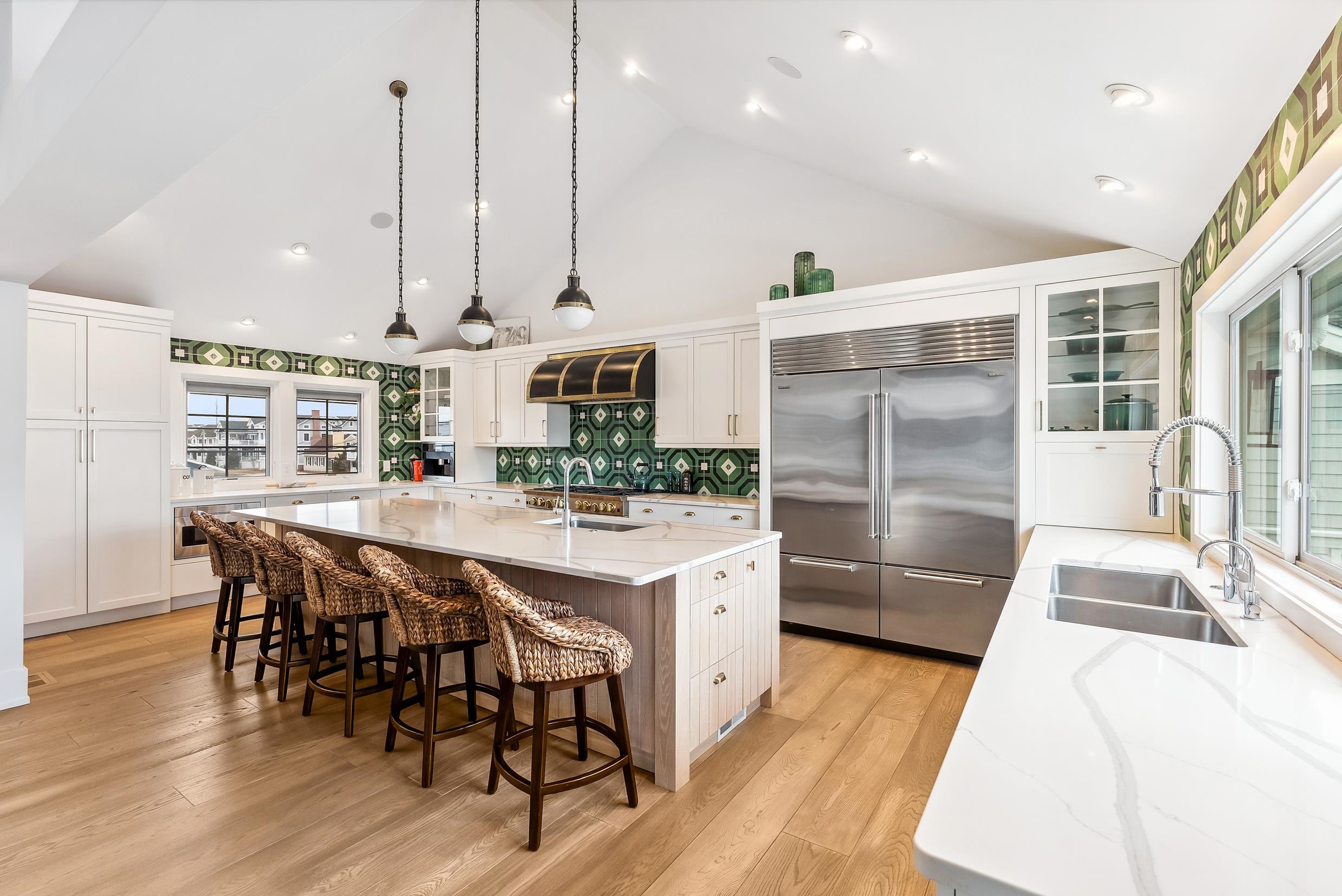7749 Dune Drive Avalon, NJ 08202 - Photo 22 of 44 a kitchen with stainless steel appliances kitchen island granite countertop a table chairs and white cabinets