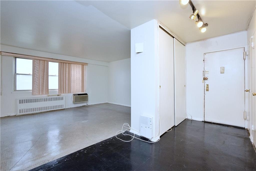 2483 West 16th Street, Unit 7H Brooklyn, NY 11214 - Photo 13 of 24 wooden floor in an empty room with a window