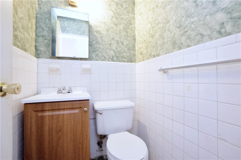 2483 West 16th Street, Unit 7H Brooklyn, NY 11214 - Photo 14 of 24 a bathroom with a toilet sink and mirror