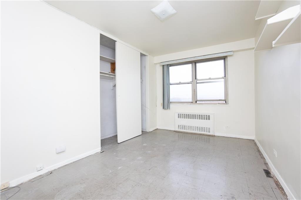 2483 West 16th Street, Unit 7H Brooklyn, NY 11214 - Photo 18 of 24 an empty room with a empty space and windows