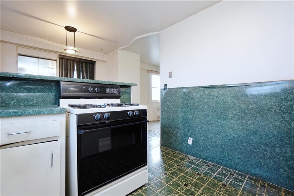 2483 West 16th Street, Unit 7H Brooklyn, NY 11214 - Photo 6 of 24 a stove top oven sitting inside of a kitchen
