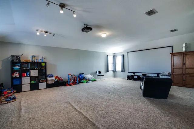 a bedroom with furniture and a flat screen tv