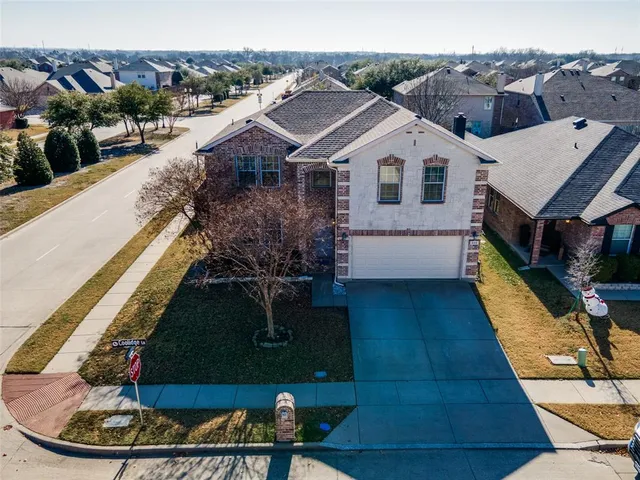 a aerial view of a house with a yard