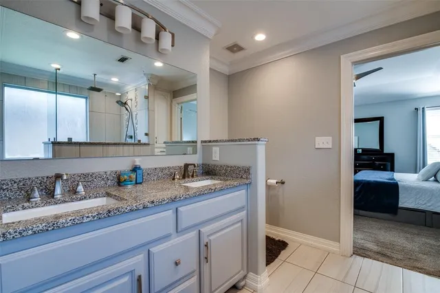 a spacious bathroom with a granite countertop sink a mirror and shower