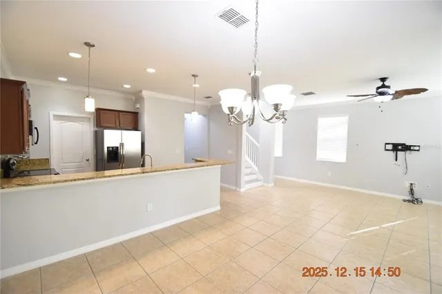 a kitchen with granite countertop a sink stove and microwave