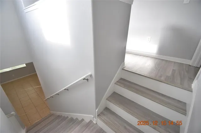 a view of an empty room with a window and a ceiling fan