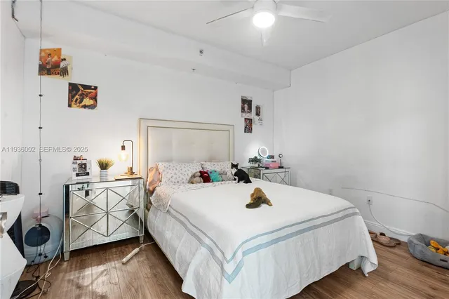 a bedroom with a bed and wooden floor