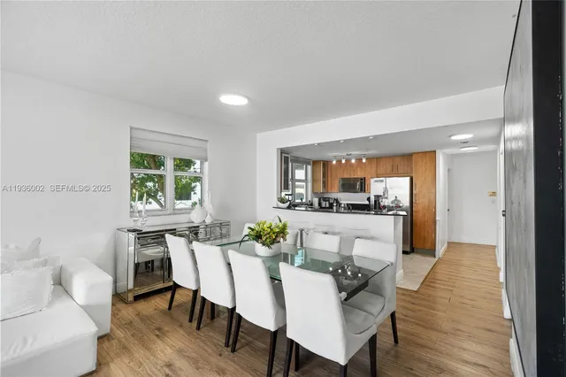 a view of a dining room with furniture and a wooden floor