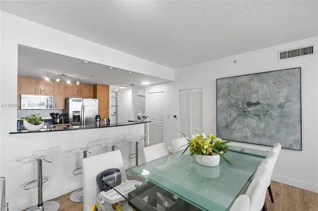 a kitchen with stainless steel appliances a refrigerator and a sink