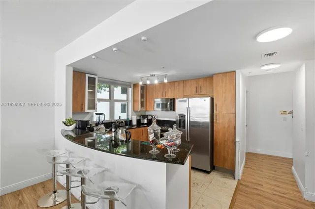 a kitchen with refrigerator and sink