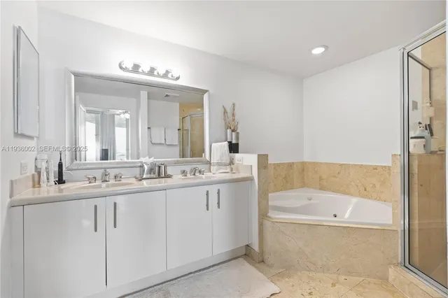 a bathroom with a tub shower sink and toilet