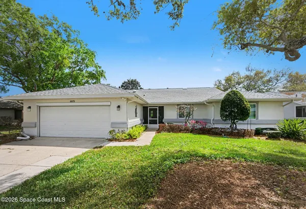 a front view of house with yard and outdoor seating
