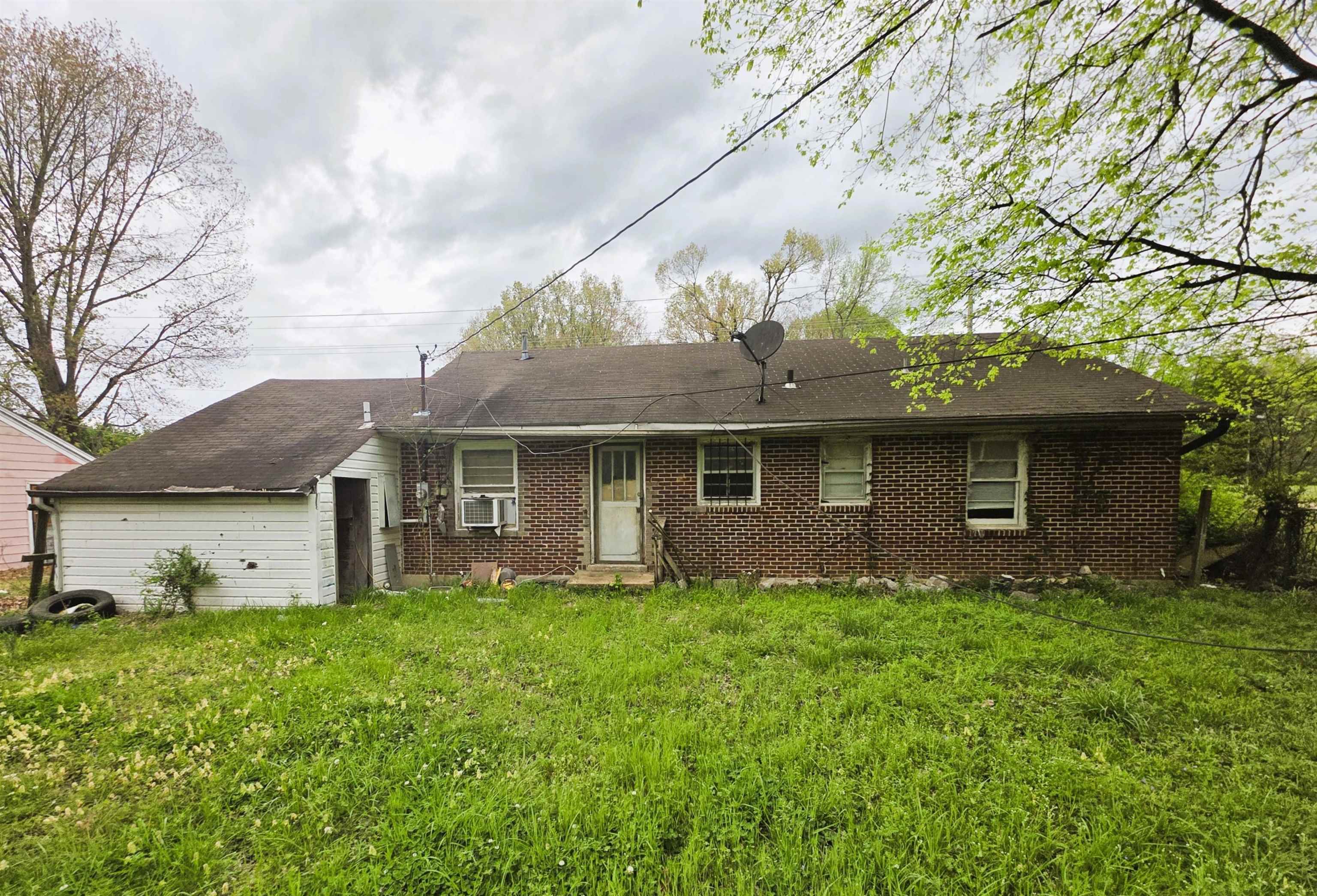 6751 Navy Road Millington, TN 38053 - Photo 2 of 14 a front view of a house with garden
