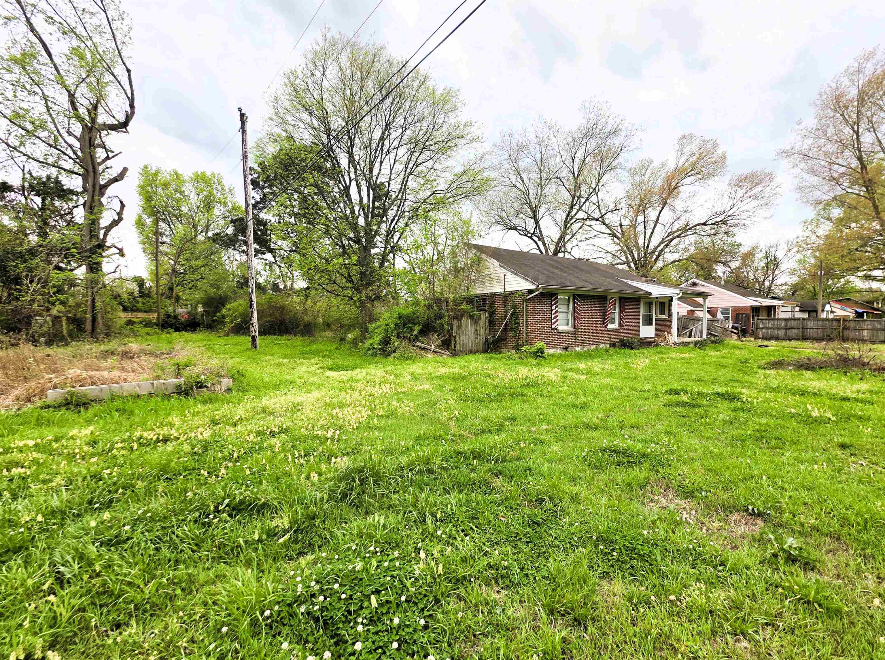 6751 Navy Road Millington, TN 38053 - Photo 3 of 14 a view of a house with a big yard and large trees