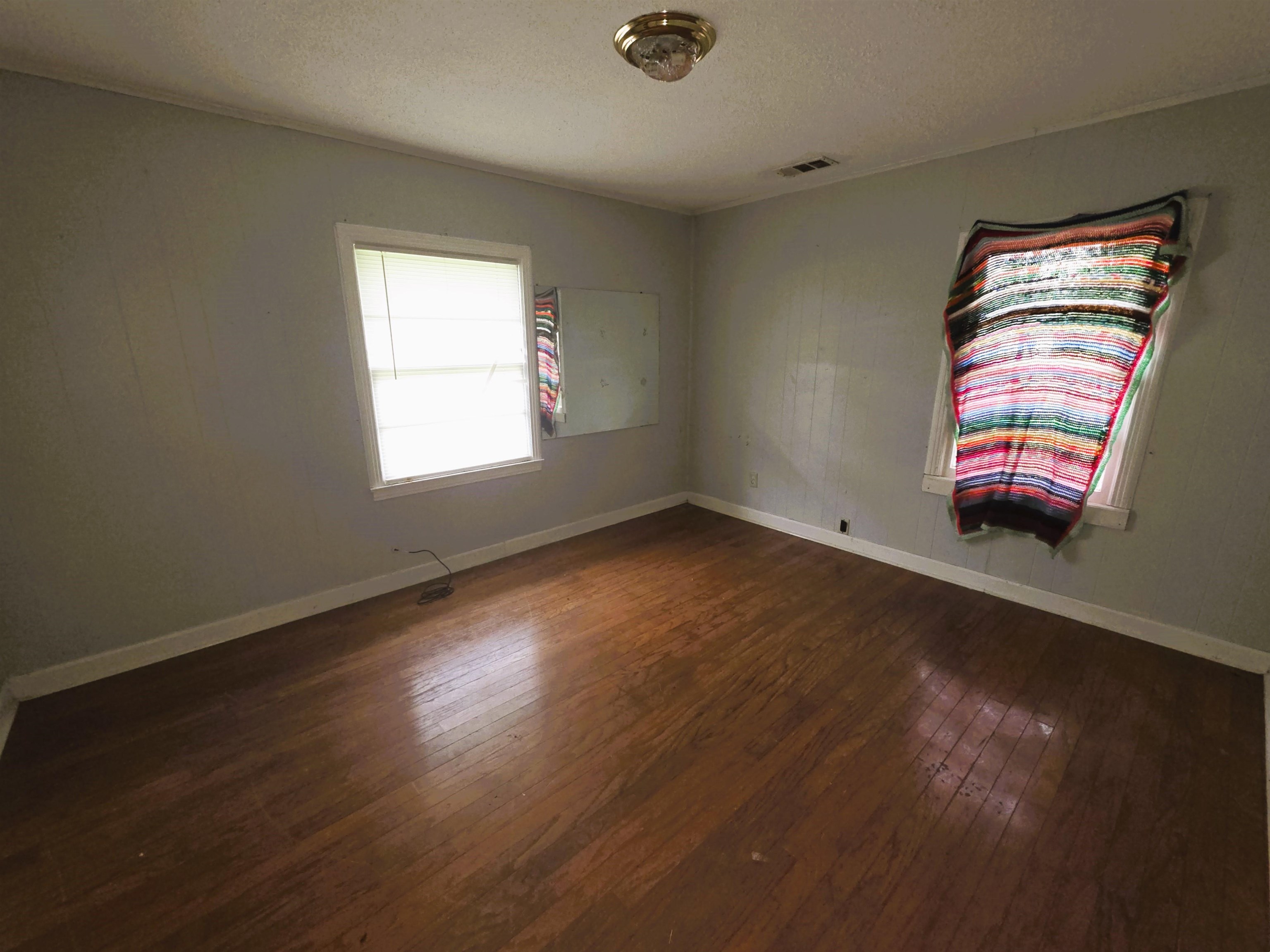 6751 Navy Road Millington, TN 38053 - Photo 9 of 14 an empty room with wooden floor and windows
