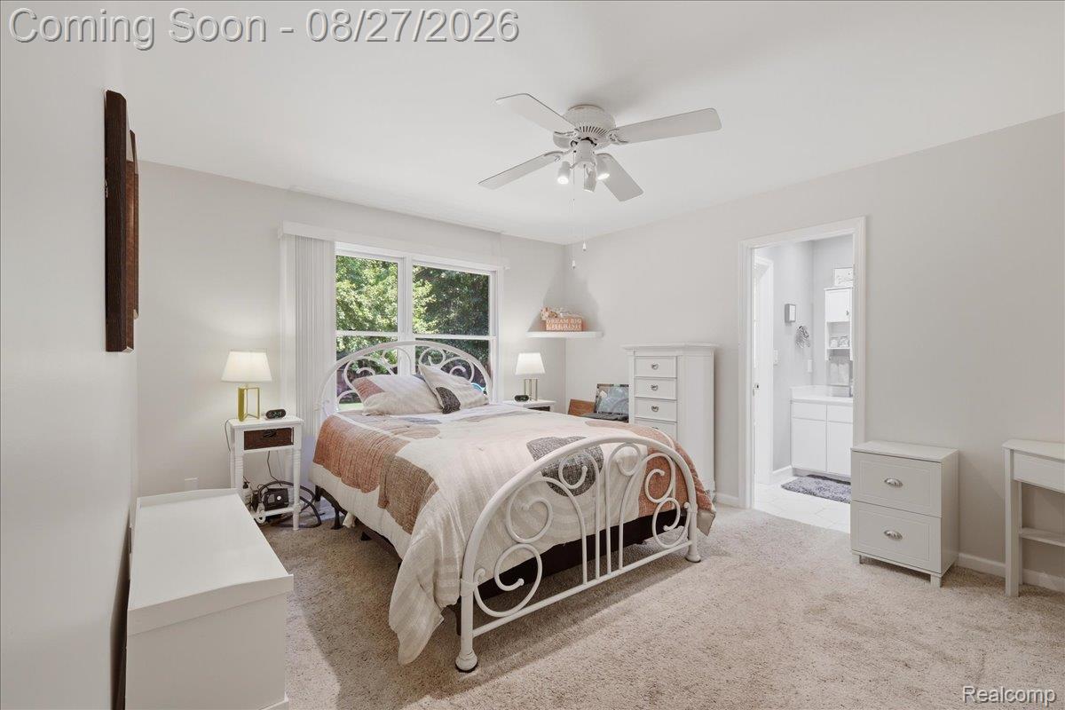 10100 Springtime Circle Clarkston, MI 48348 - Photo 32 of 73 Carpeted flooring, white walls, ceiling fan with integrated lighting, and a large window with white window treatments