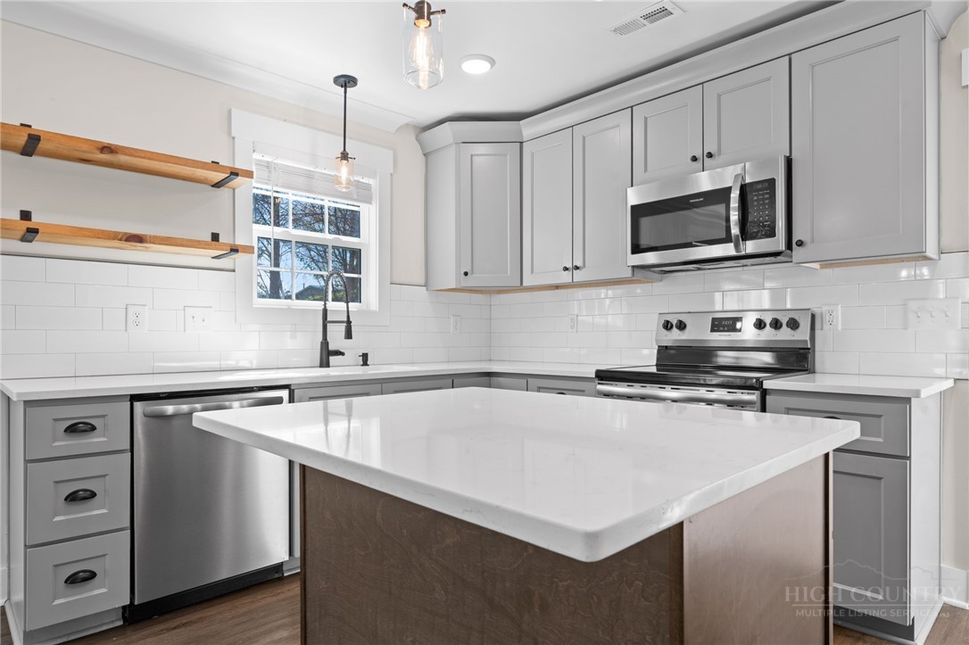 228 Stratford Lane Boone, NC 28607 - Photo 12 of 33 a kitchen with stainless steel appliances white cabinets and a sink