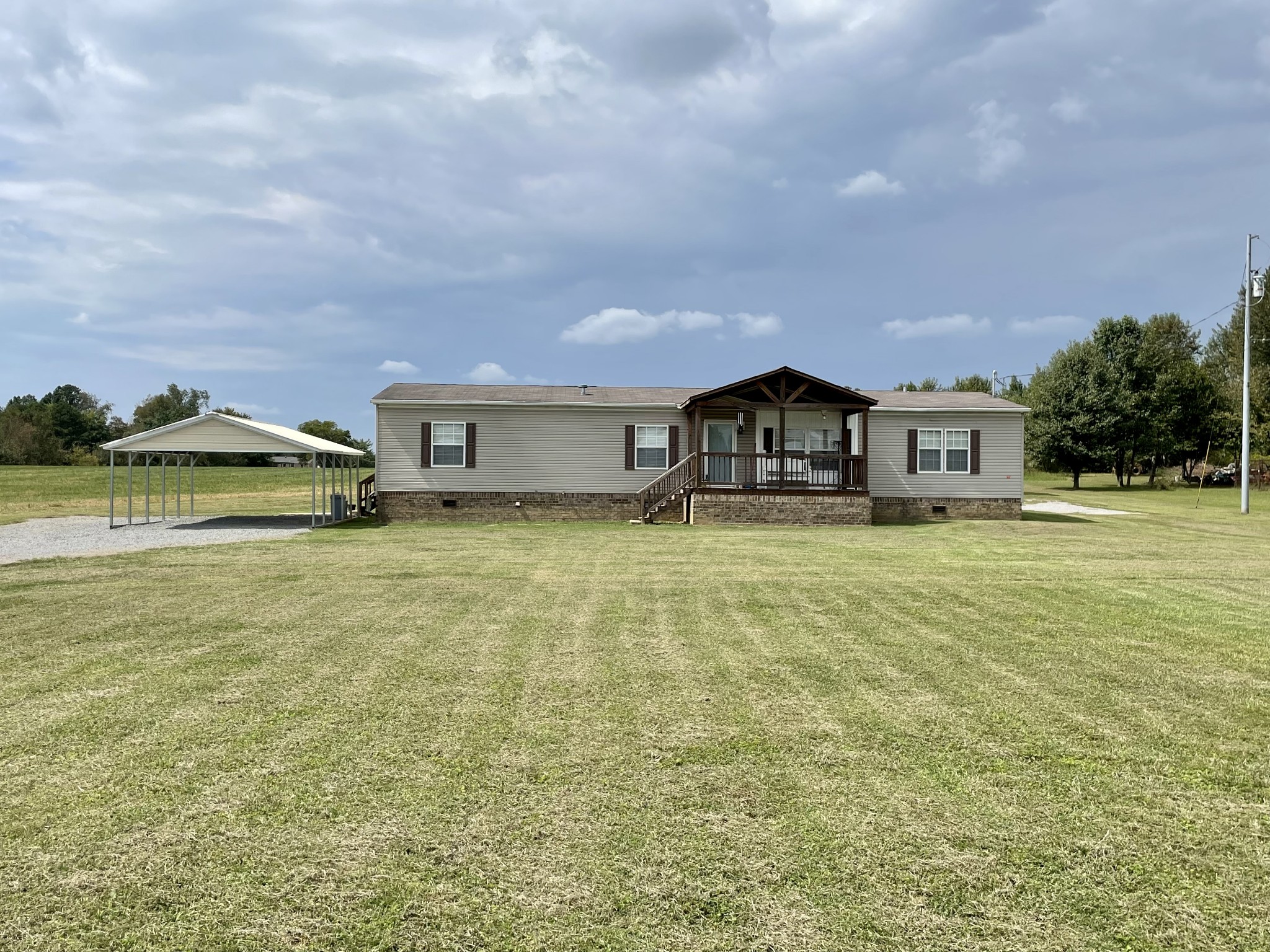 36 Ben Thompson Road Kelso, TN 37348 - Photo 3 of 46 a front view of a house with swimming pool and green space