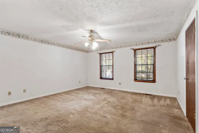 a view of an empty room with windows