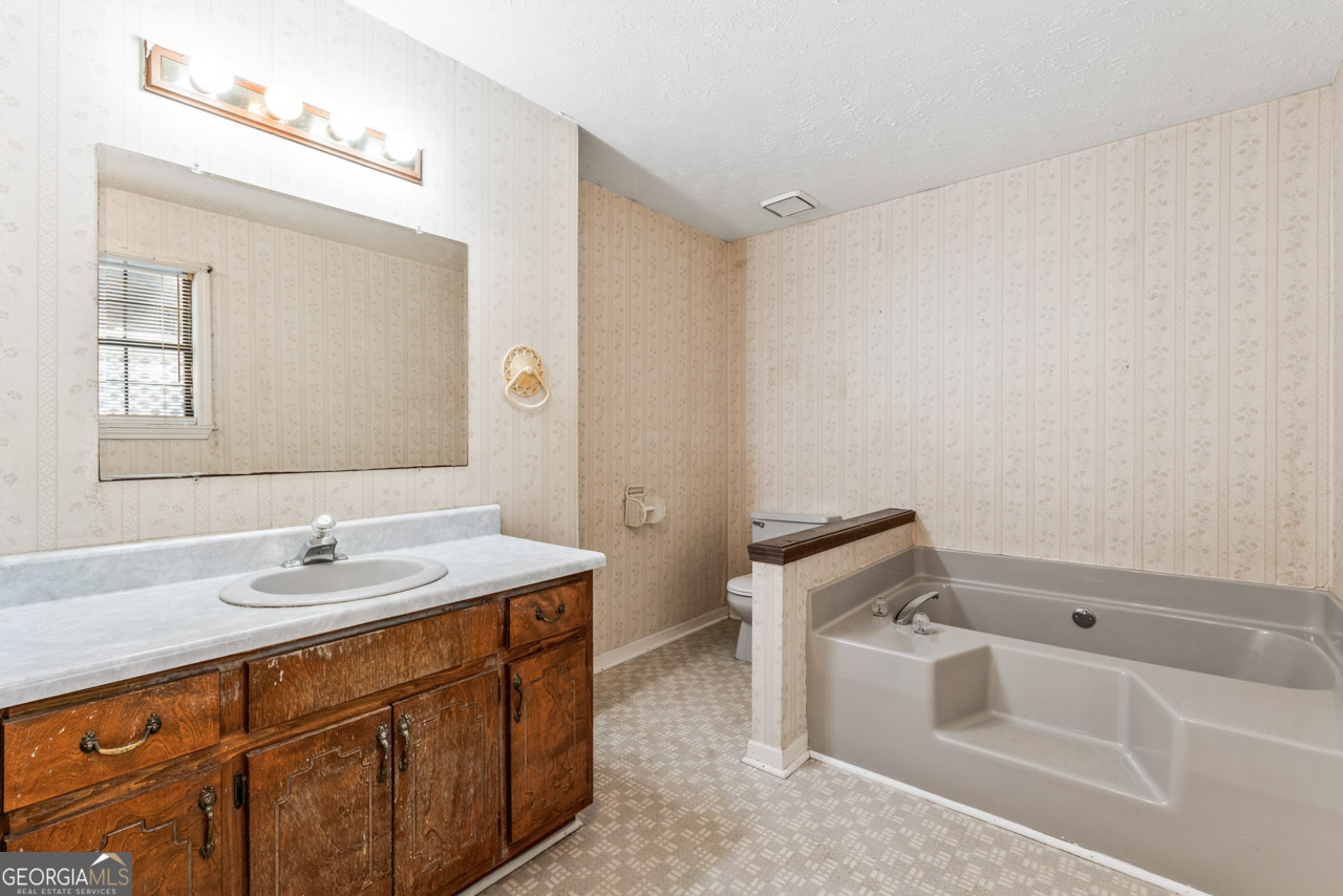 75 Antioch Road McDonough, GA 30252 - Photo 18 of 40 a bathroom with a sink and a mirror