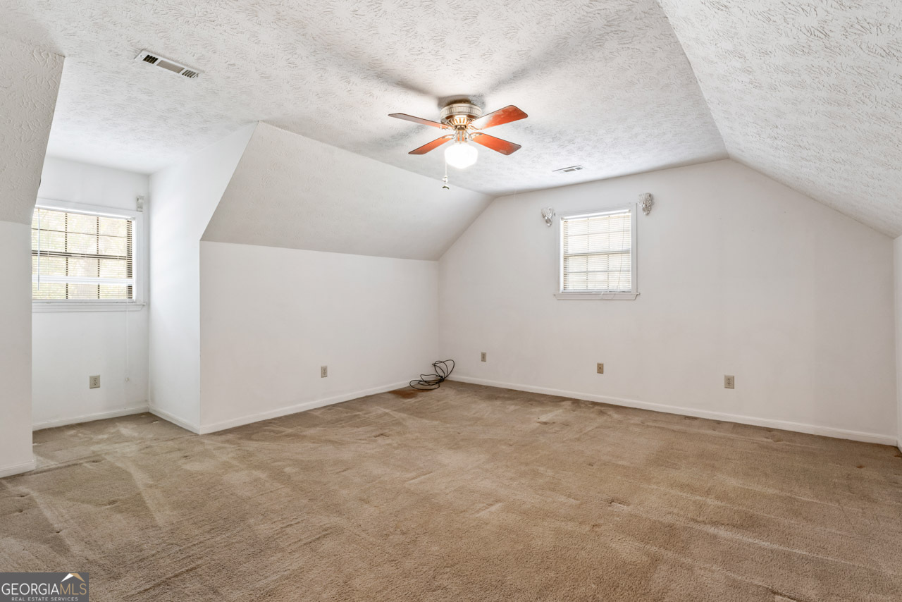 75 Antioch Road McDonough, GA 30252 - Photo 20 of 40 an empty room with windows and ceiling fan view