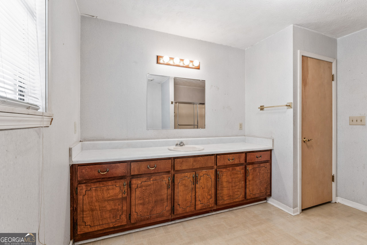 75 Antioch Road McDonough, GA 30252 - Photo 22 of 40 a bathroom with a sink and a mirror