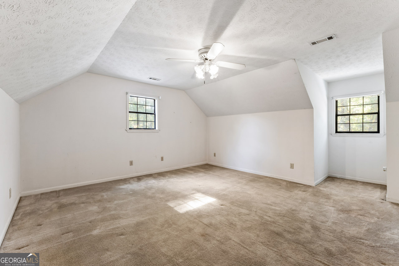 75 Antioch Road McDonough, GA 30252 - Photo 23 of 40 an empty room with windows and ceiling fan view