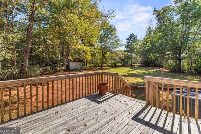 a balcony with wooden floor and fence