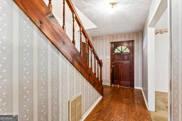 a view of an entryway with wooden floor
