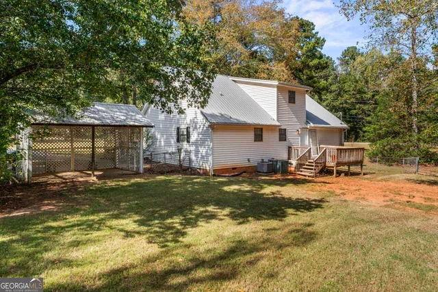 a view of a house with a yard and sitting area