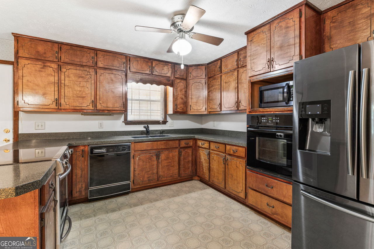 75 Antioch Road McDonough, GA 30252 - Photo 4 of 40 a kitchen with stainless steel appliances granite countertop a refrigerator and a stove top oven