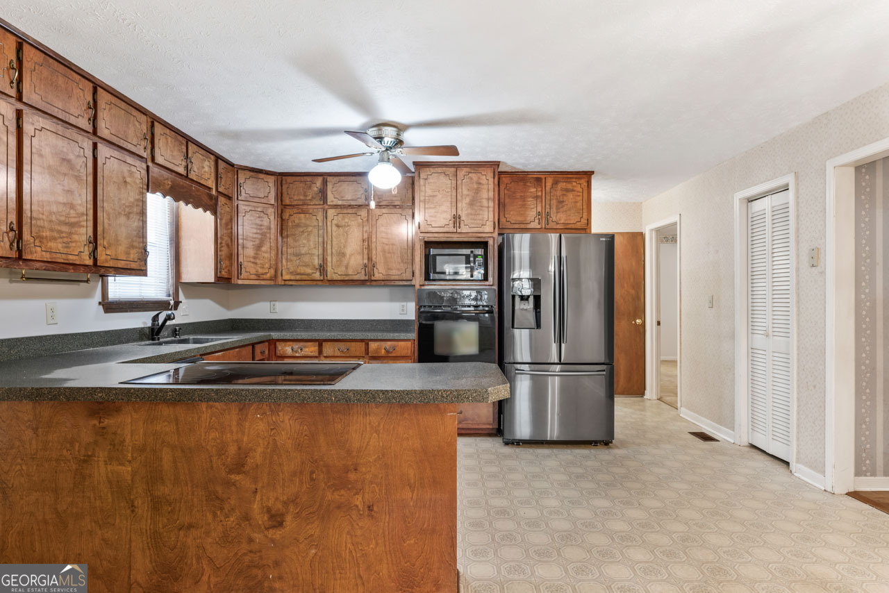75 Antioch Road McDonough, GA 30252 - Photo 5 of 40 a kitchen with stainless steel appliances granite countertop a refrigerator a sink and a stove