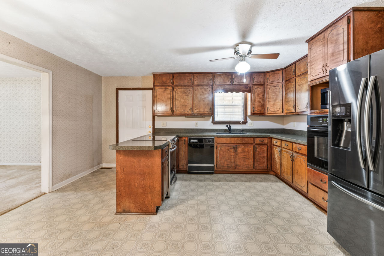 75 Antioch Road McDonough, GA 30252 - Photo 6 of 40 a large kitchen with stainless steel appliances granite countertop a stove a sink dishwasher a refrigerator and a microwave