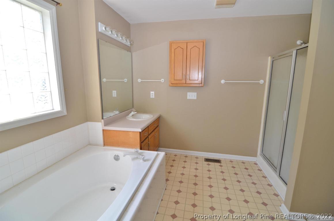 75 Natalie Drive Raleigh, NC 27603 - Photo 22 of 24 a bathroom with a bathtub and a sink