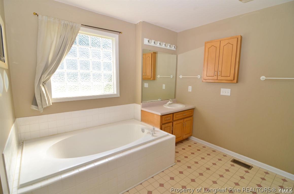 75 Natalie Drive Raleigh, NC 27603 - Photo 23 of 24 a bathroom with a sink and a bathtub