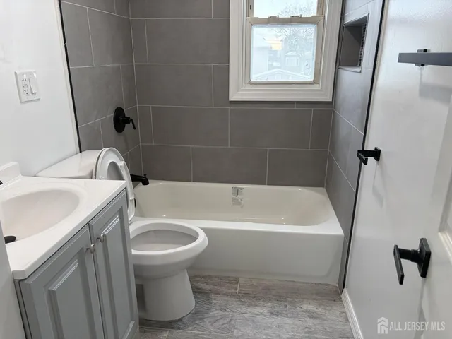 a bathroom with a sink a toilet and a bathtub