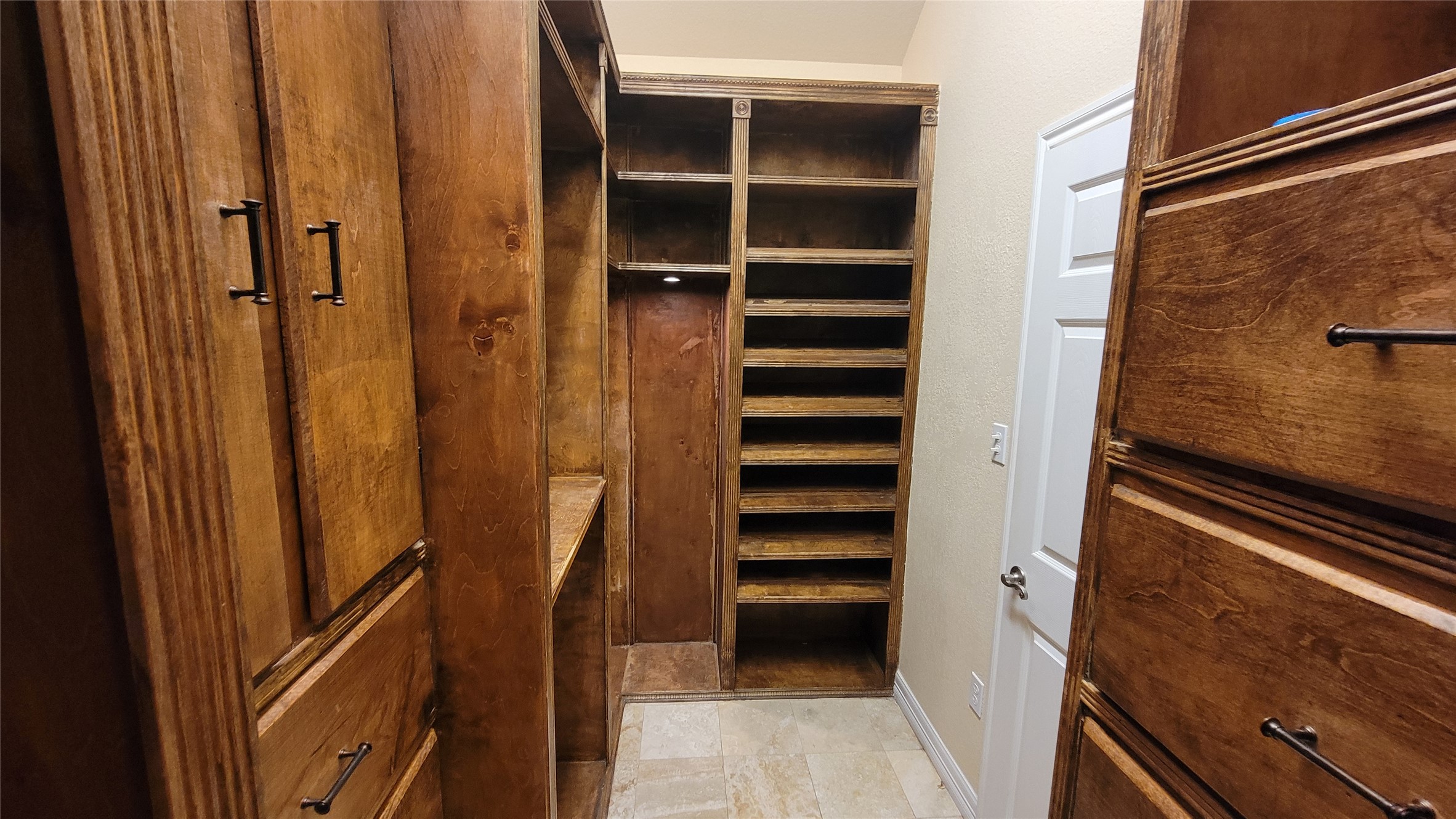 2832 Grimes Ranch Road Austin, TX 78732 - Photo 30 of 37 Ample built-in wooden cabinetry and shelving offer exceptional storage in this well-organized space.