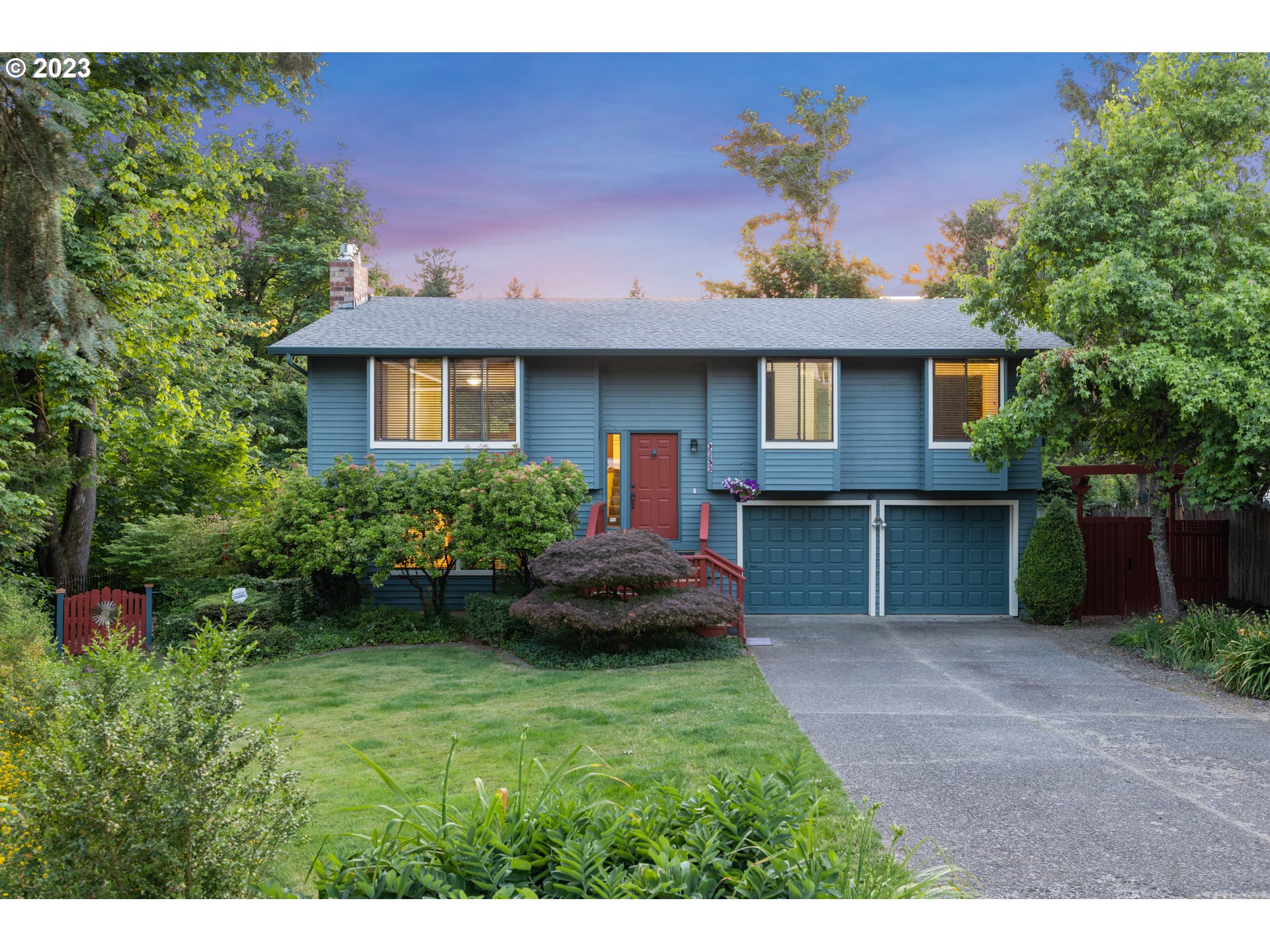 a front view of a house with a garden