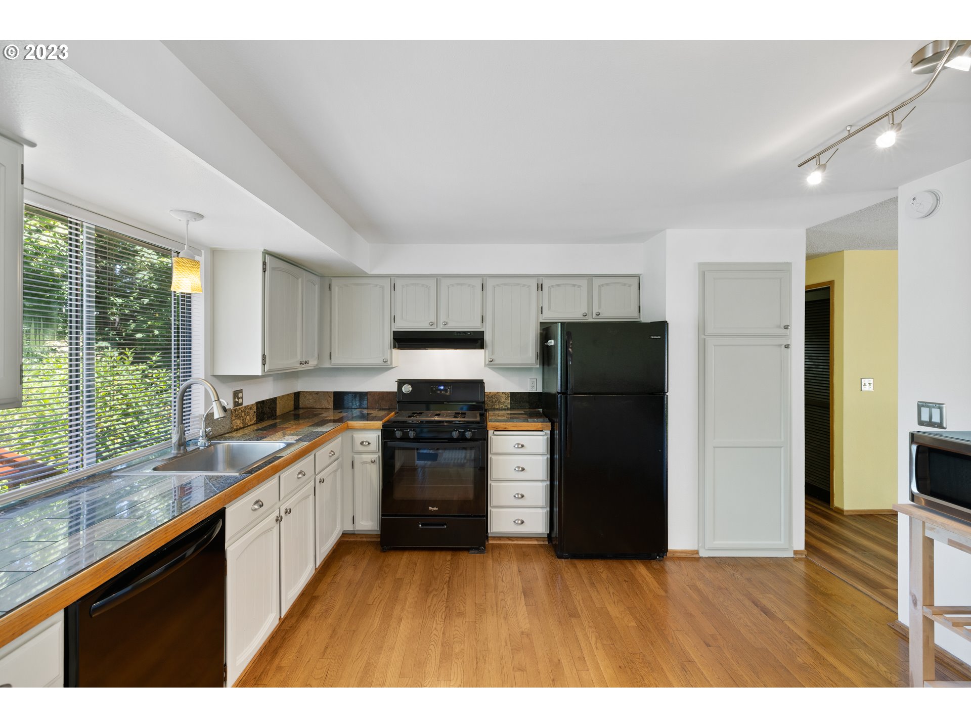 1757 Southwest 19th Court Gresham, OR 97080 - Photo 12 of 31 a kitchen with granite countertop a refrigerator stove and sink