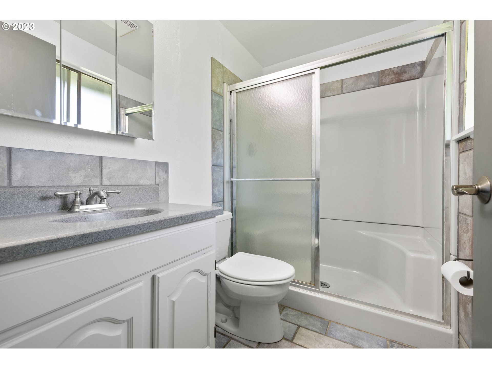 1757 Southwest 19th Court Gresham, OR 97080 - Photo 16 of 31 a bathroom with a sink a mirror toilet and shower