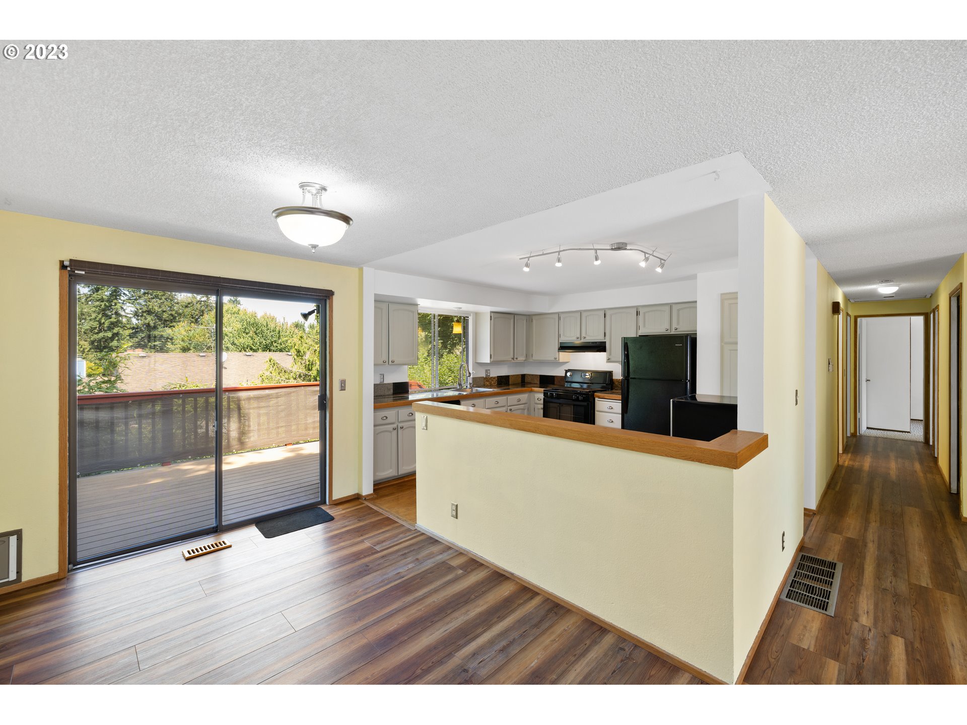 1757 Southwest 19th Court Gresham, OR 97080 - Photo 10 of 31 a view of a kitchen with furniture wooden floor and windows