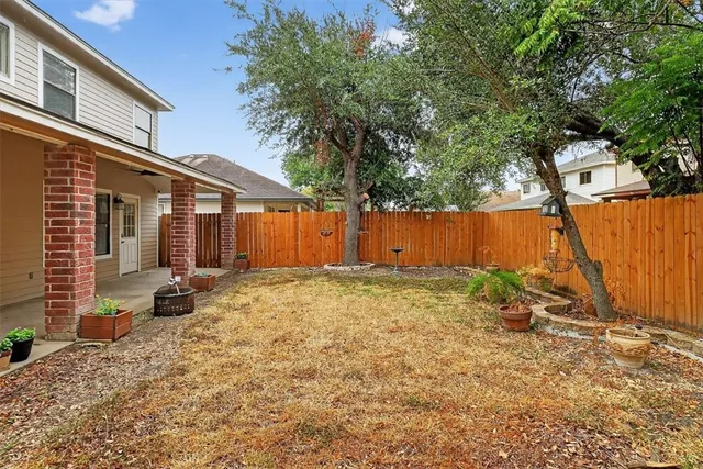 a backyard of a house with yard and outdoor seating